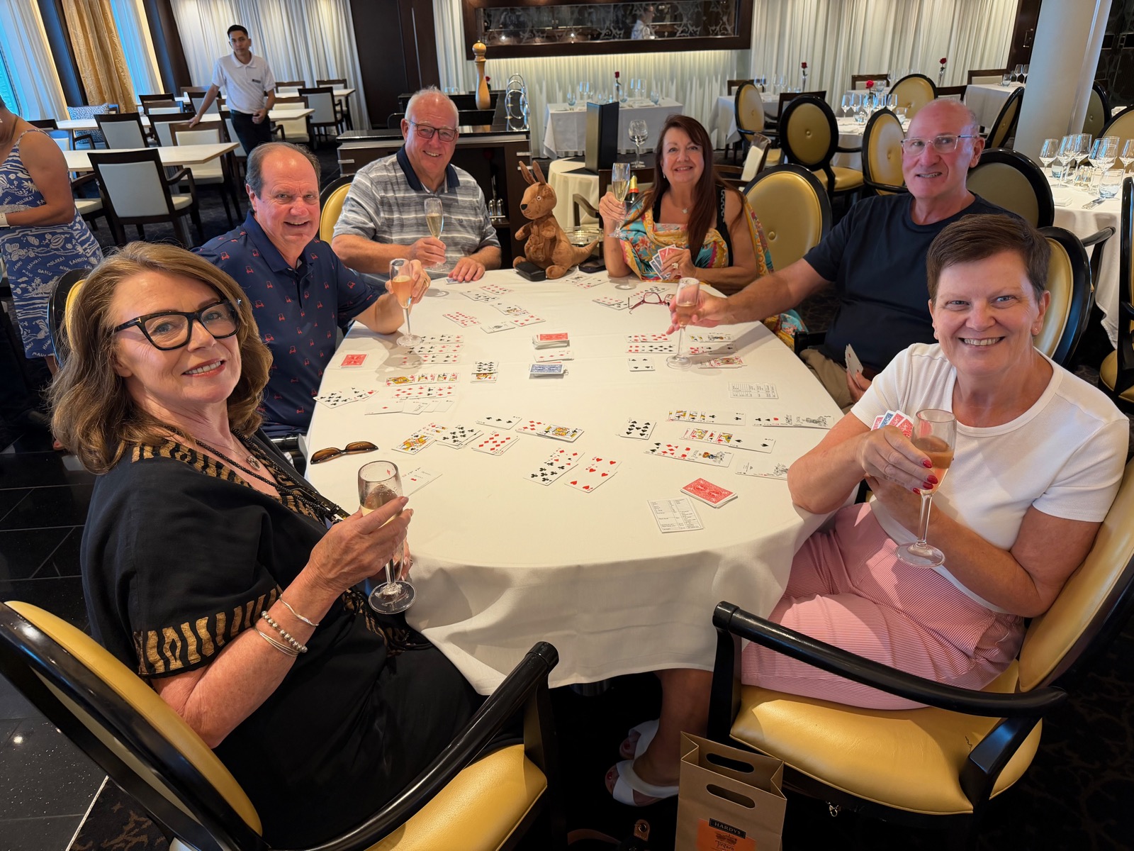 Friends playing Hand and Foot around a table on a cruise ship